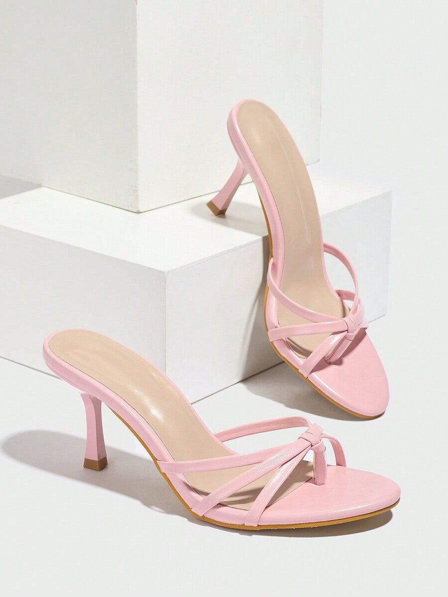 Women's slip-on stiletto heel platform sandals featuring a twist toe-post strap design and sleek finish.