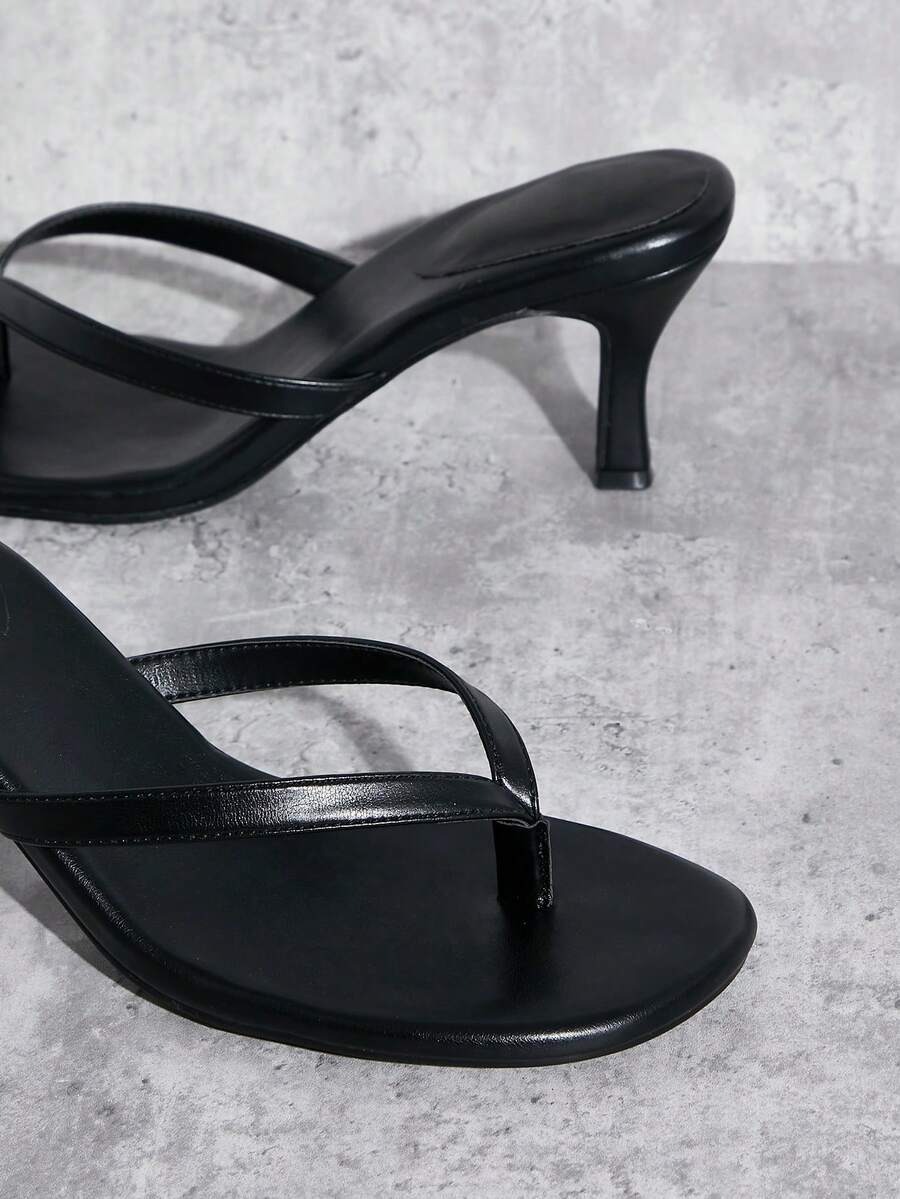 Women's minimalist black PU leather thong heel sandals featuring kitten heels and rhinestone accents