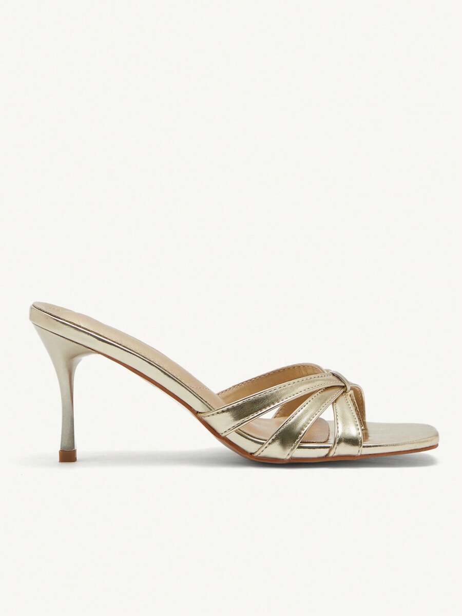 Square toe gold metallic heel sandals for women featuring open toe, crossover slingback strap, and stiletto mid heel for weddings and parties.