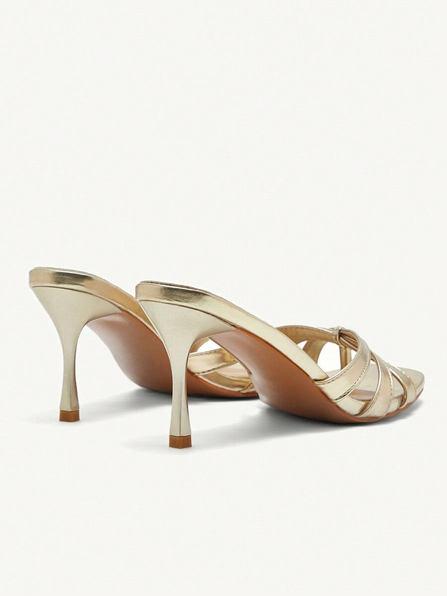 Square toe gold metallic heel sandals for women featuring open toe, crossover slingback strap, and stiletto mid heel for weddings and parties.