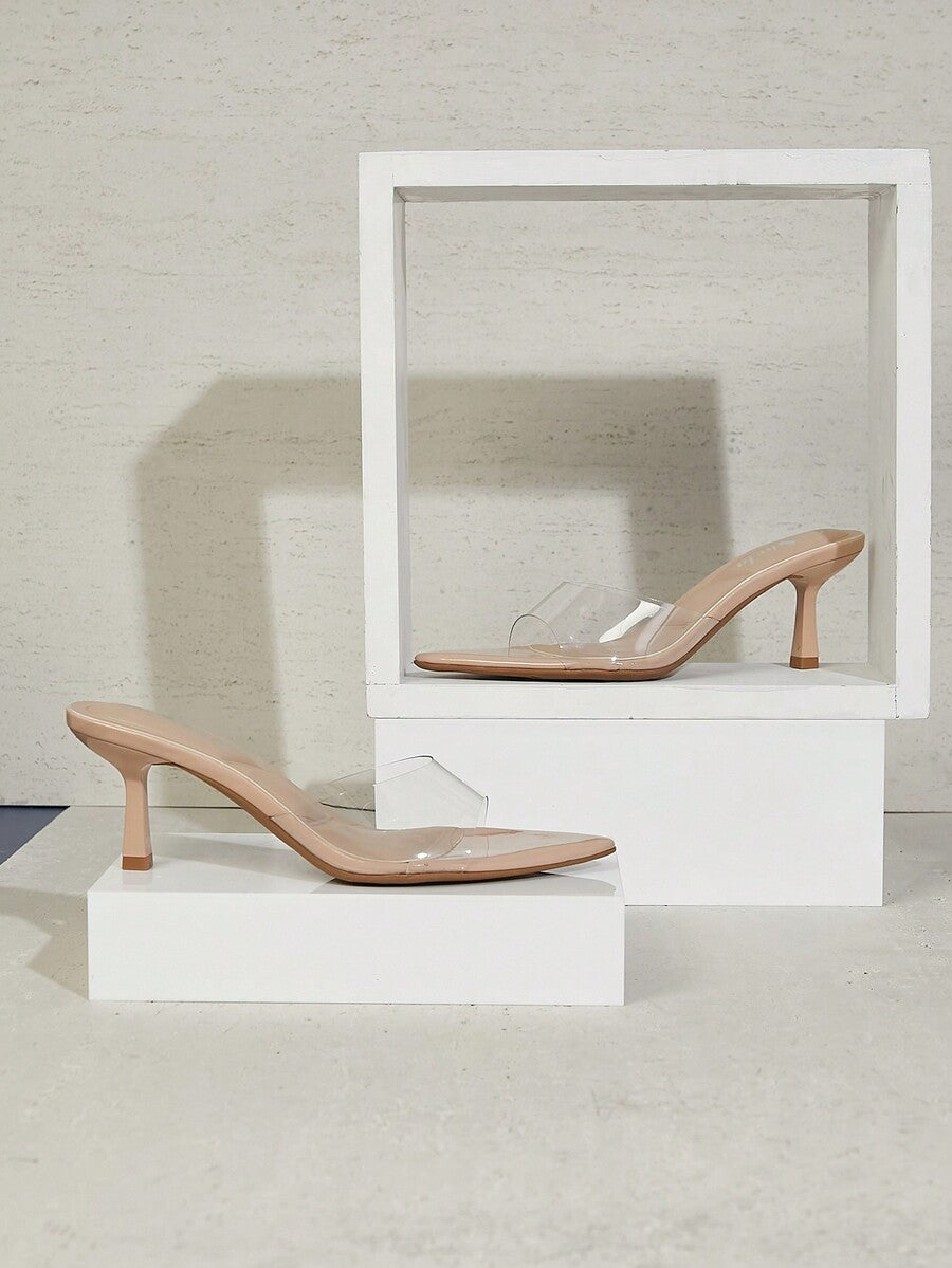 Black pointy toe kitten heel shoes for women featuring a sleek cut out mule design and glossy patent leather finish.