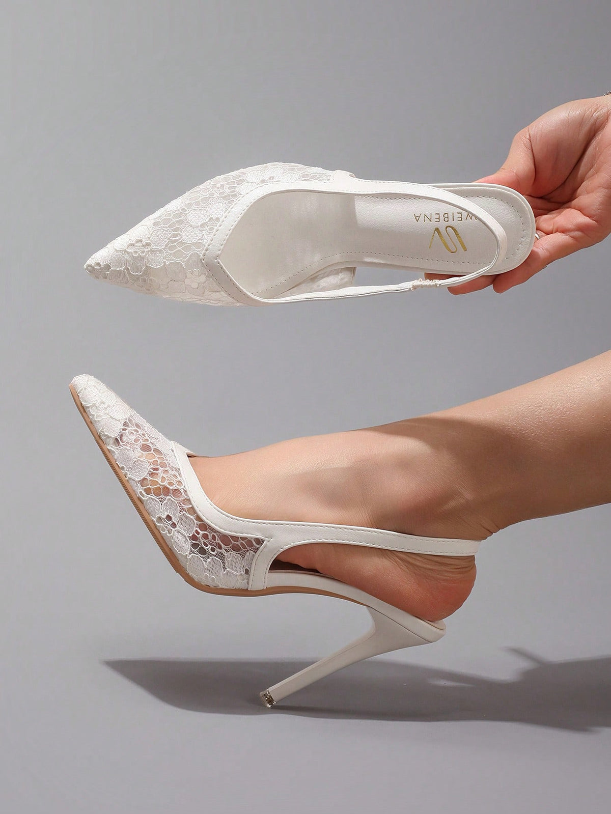Black lace pointed toe high heel pumps featuring stiletto heels and a decorative bow accent.
