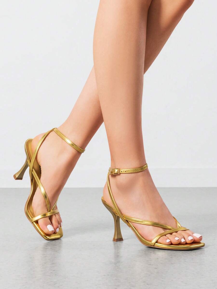 Women's metallic kitten low heel thong sandals featuring an open square toe and slip-on mule design.