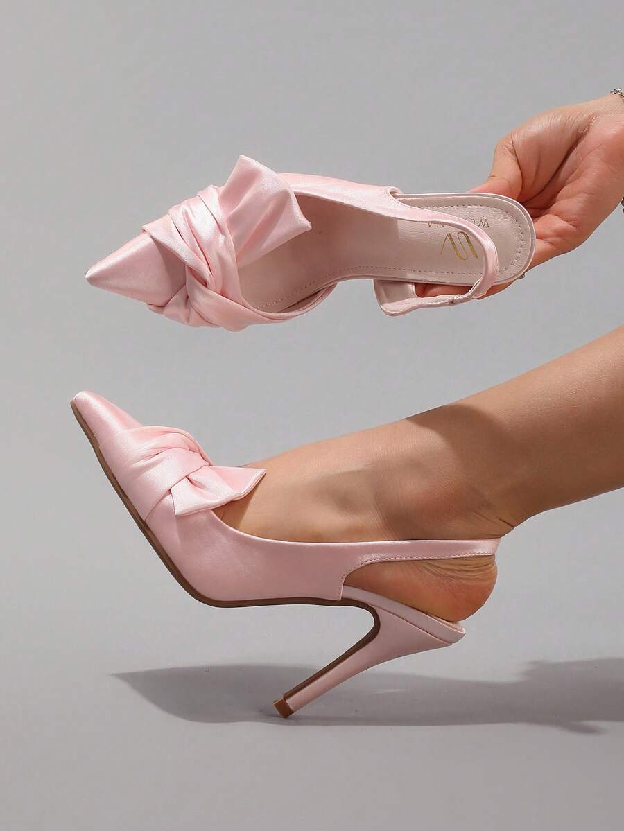 Lace embroidered high heels with thin stiletto heel, pointed toe, rhinestone embellishments, and ankle strap buckle closure.