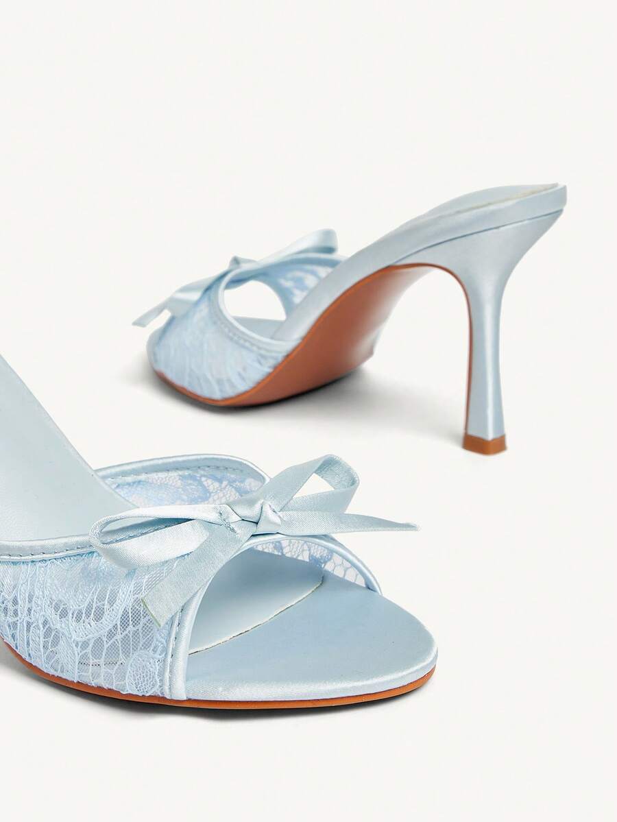Elegant women's pointed toe high heel mules crafted from smooth PU leather with stiletto heels and delicate bow detail.