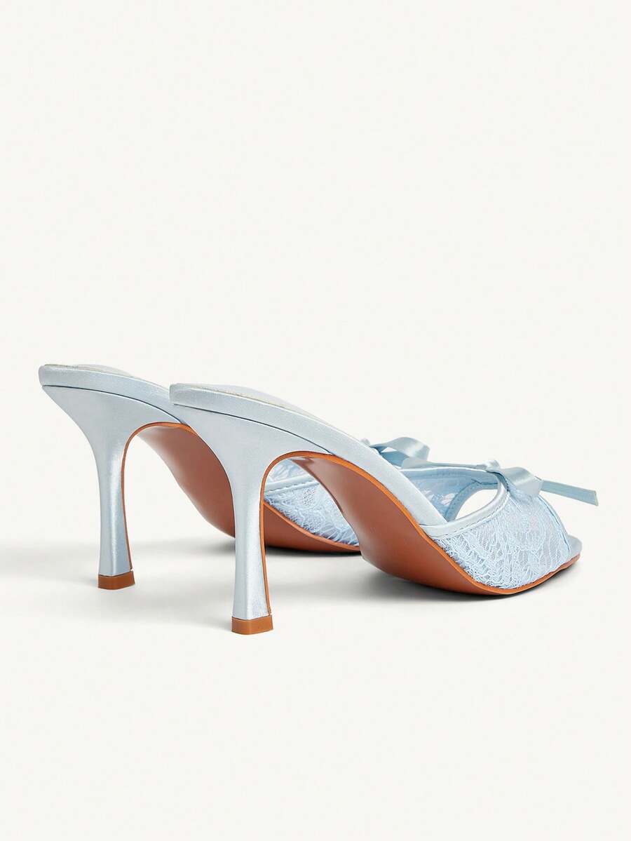 Elegant women's pointed toe high heel mules crafted from smooth PU leather with stiletto heels and delicate bow detail.