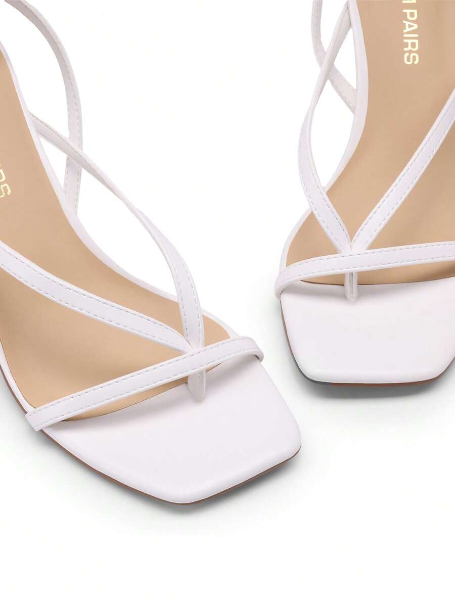 Open square toe kitten heel thong sandals with delicate cross-over straps and an adjustable ankle buckle strap.