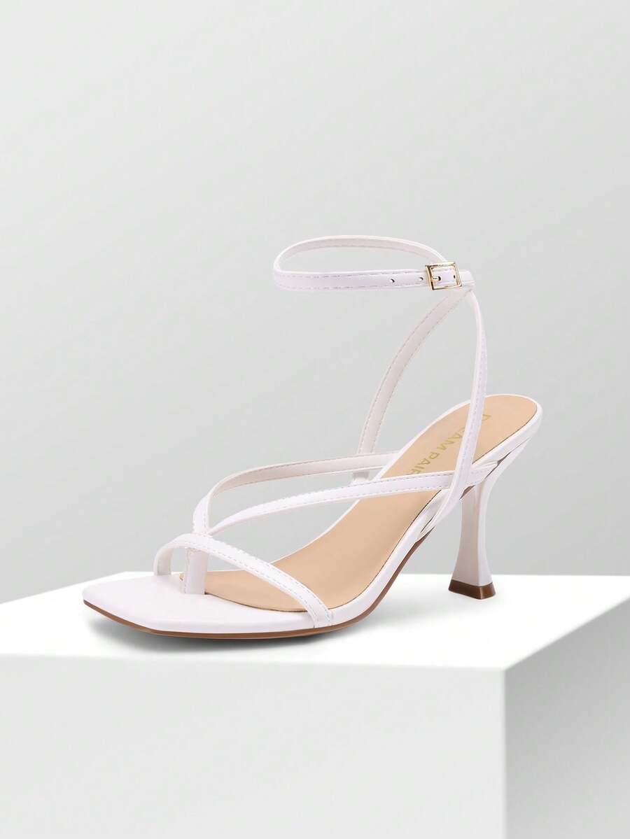 Open square toe kitten heel thong sandals with delicate cross-over straps and an adjustable ankle buckle strap.