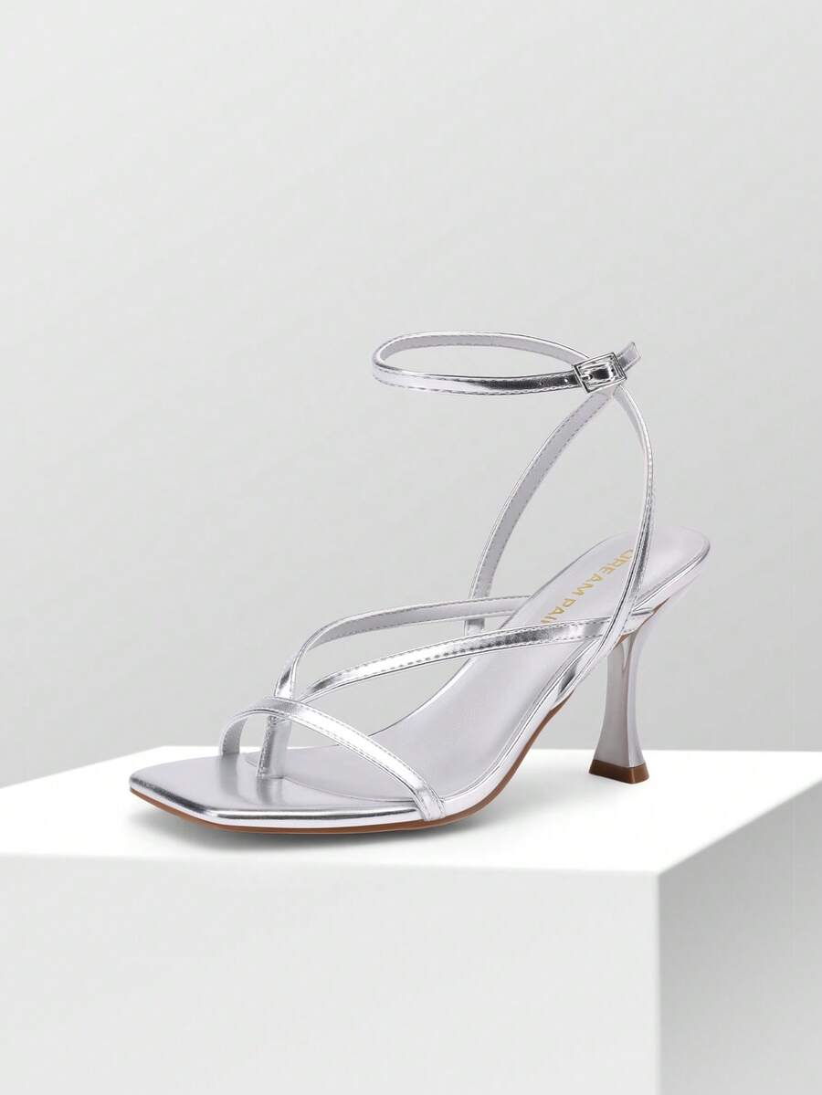 Open square toe kitten heel thong sandals with delicate cross-over straps and an adjustable ankle buckle strap.