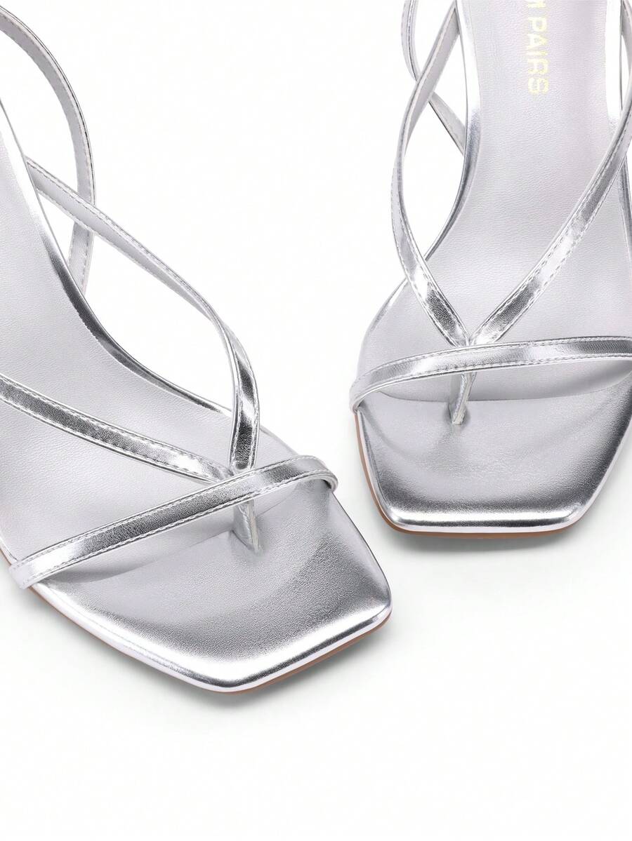 Open square toe kitten heel thong sandals with delicate cross-over straps and an adjustable ankle buckle strap.
