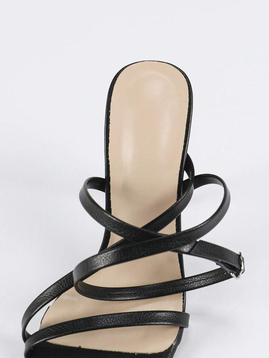 Glossy high heel sandals with open round toe, stiletto heel, and cross ankle buckle strap
