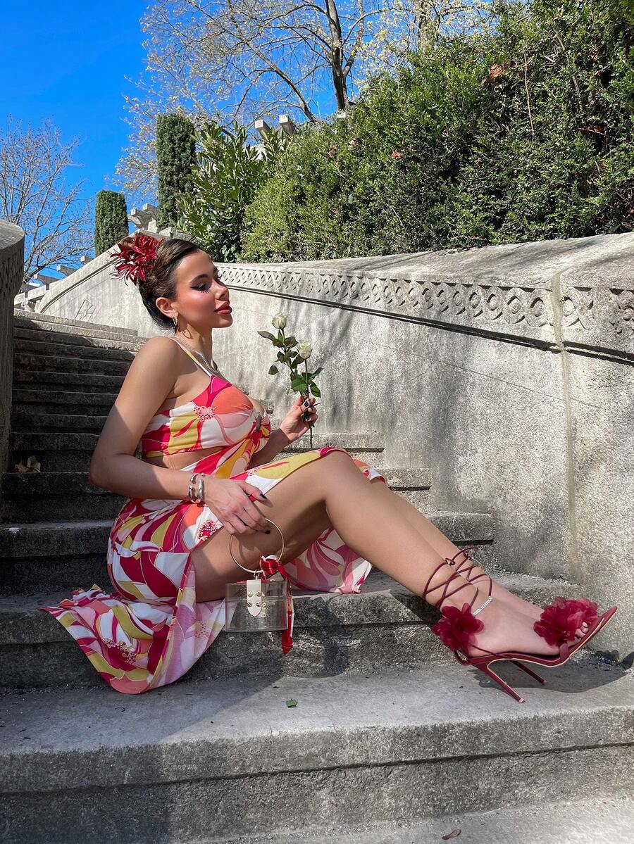 Women's open toe heeled sandals featuring 3D floral decor, satin lace-up ankle straps, and stiletto high heels.