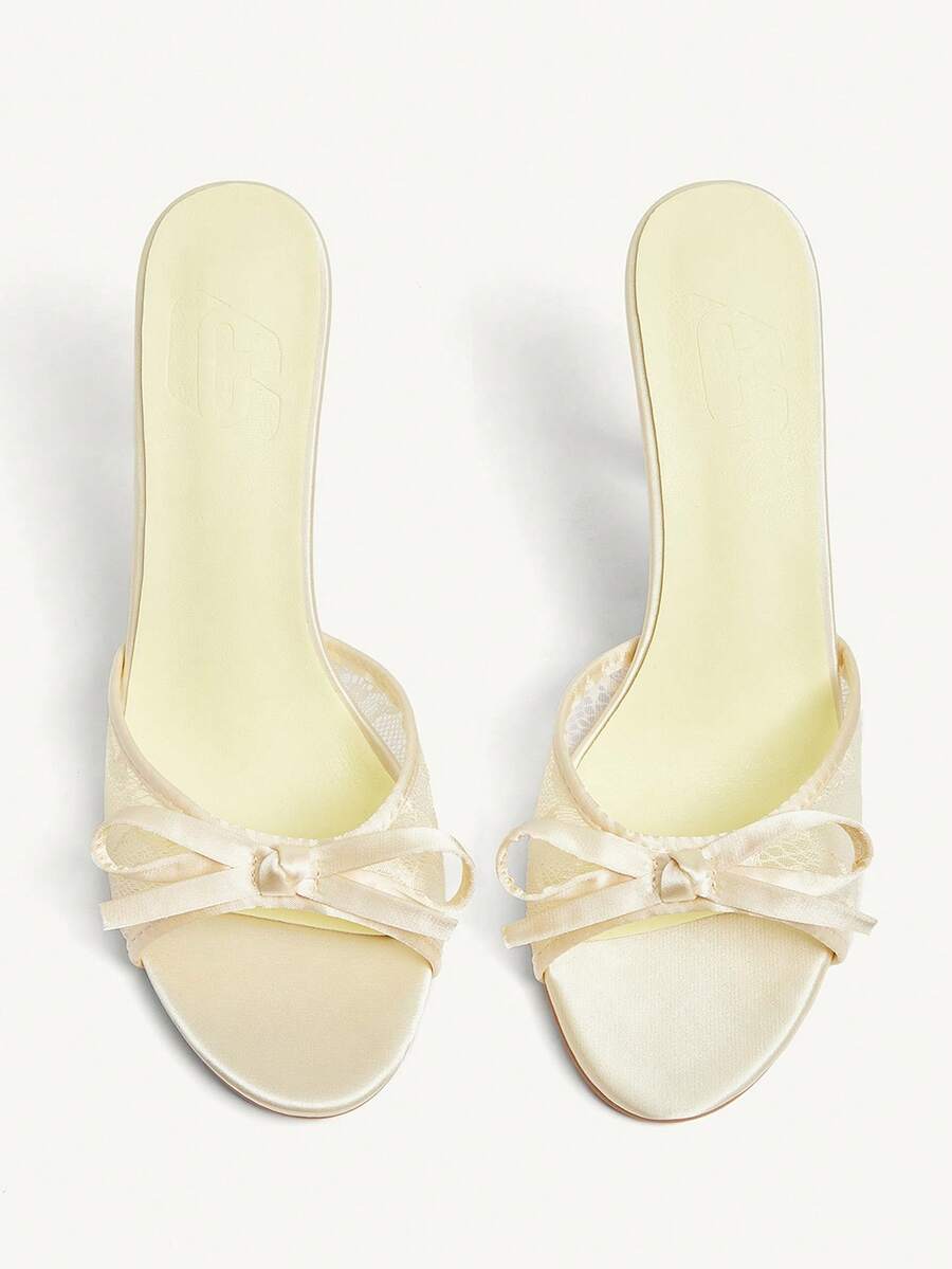 Elegant women's pointed toe high heel mules crafted from smooth PU leather with stiletto heels and delicate bow detail.