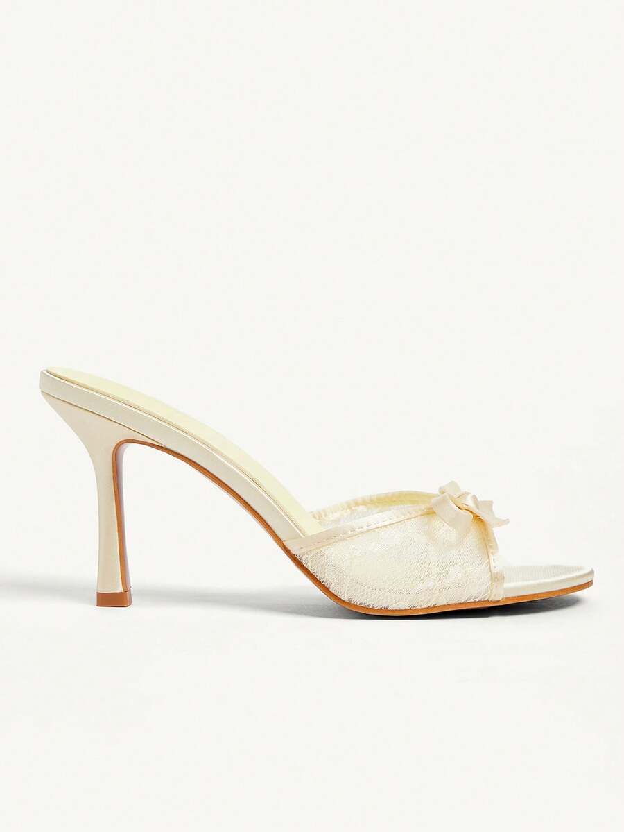 Elegant women's pointed toe high heel mules crafted from smooth PU leather with stiletto heels and delicate bow detail.