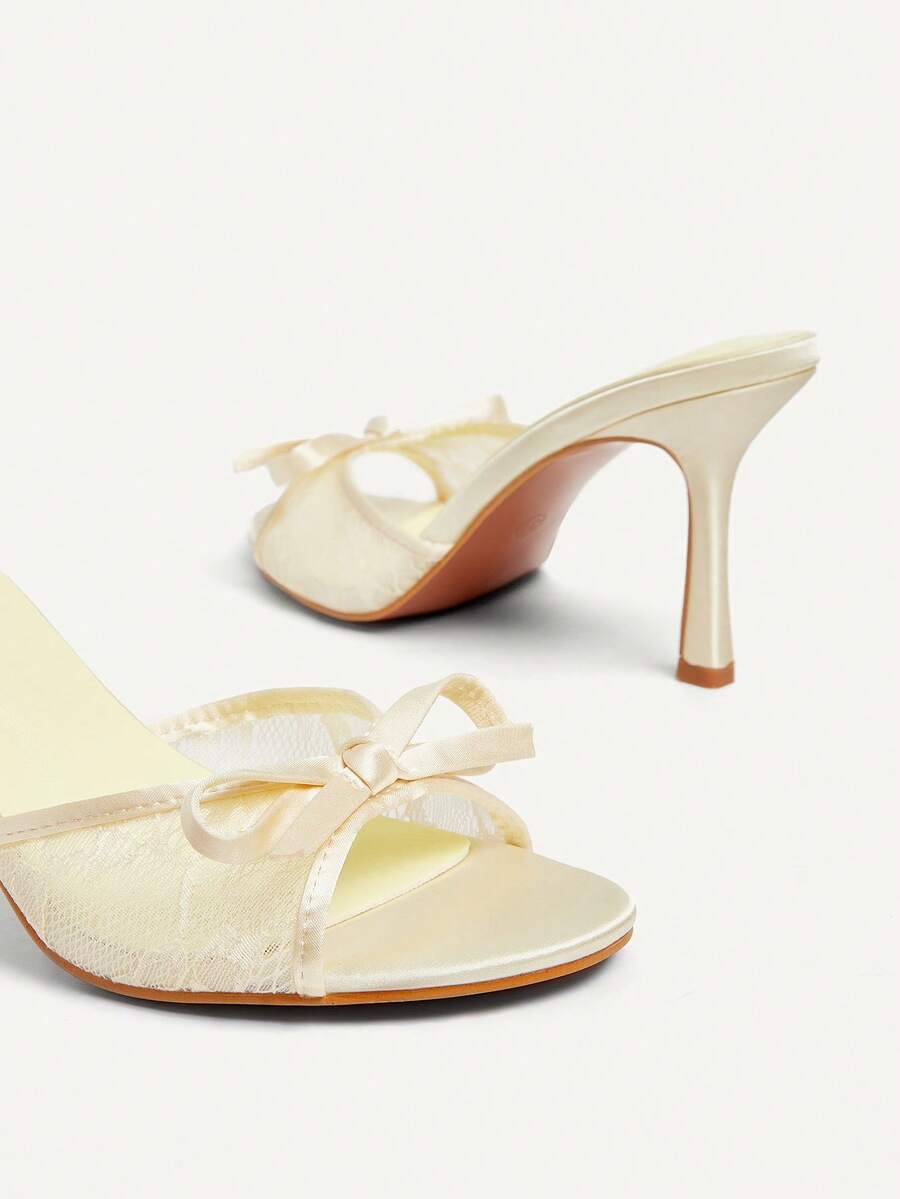 Elegant women's pointed toe high heel mules crafted from smooth PU leather with stiletto heels and delicate bow detail.