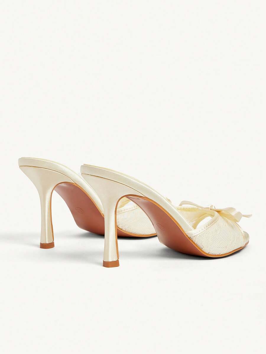 Elegant women's pointed toe high heel mules crafted from smooth PU leather with stiletto heels and delicate bow detail.