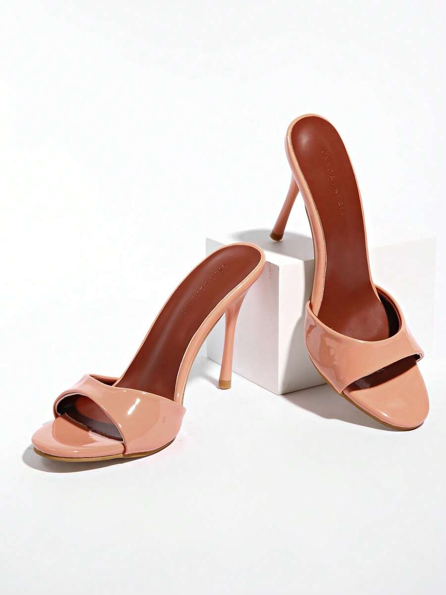 Patent leather open toe slingback slide sandals with stiletto high heels and slip on design.