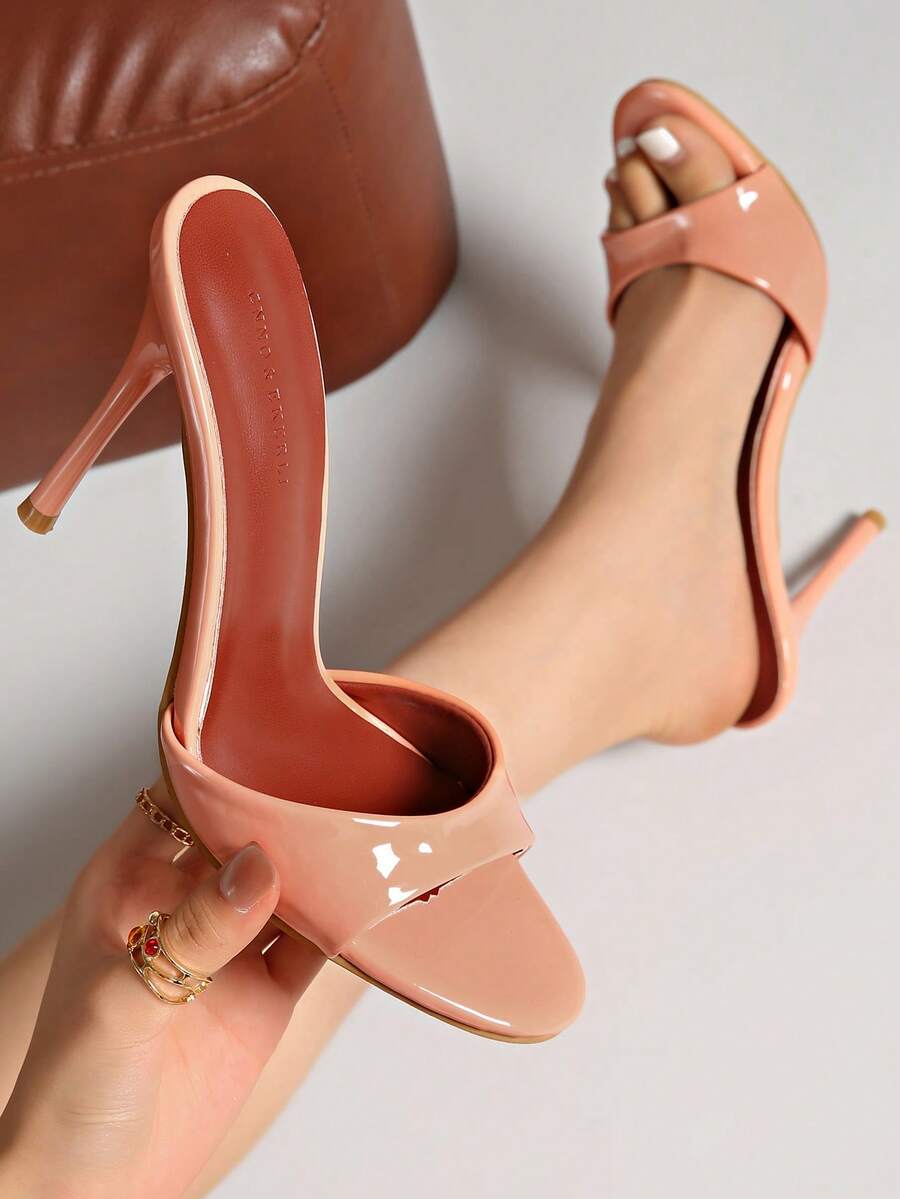 Patent leather open toe slingback slide sandals with stiletto high heels and slip on design.