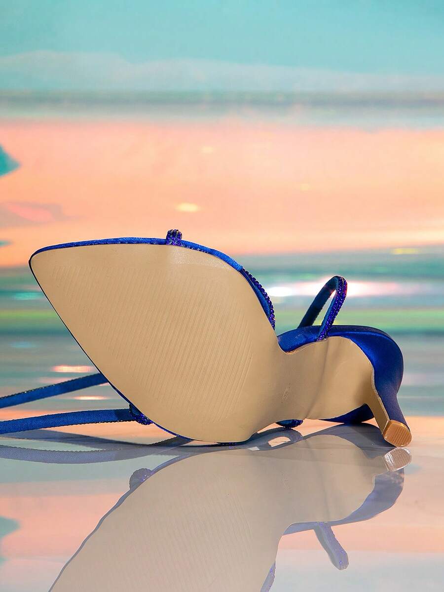 Women's strappy stiletto high heel sandals featuring an open toe design and adjustable buckle closure