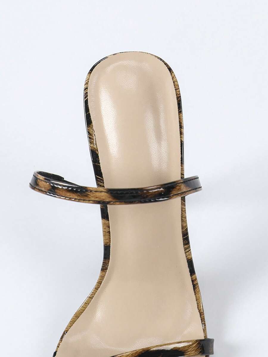 Women's stiletto high heel sandals with round open toe and back ankle strap in solid finish.