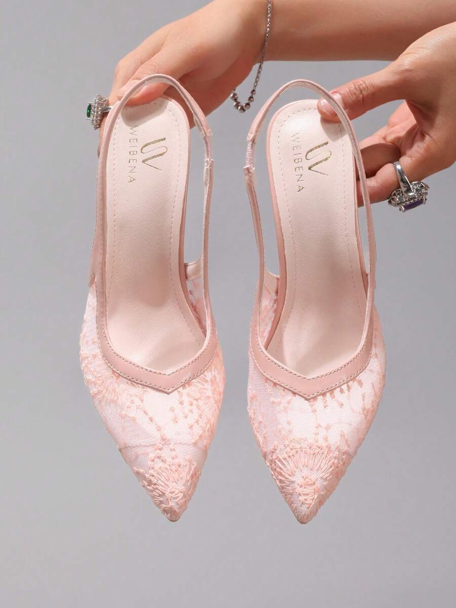 Black lace pointed toe high heel pumps featuring stiletto heels and a decorative bow accent.