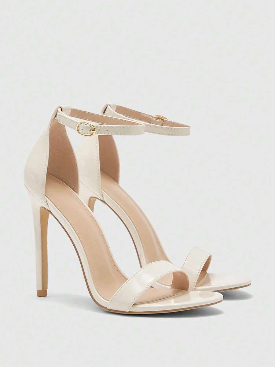 Women's stiletto sandals featuring an ankle strap buckle closure and classic round open toe design.