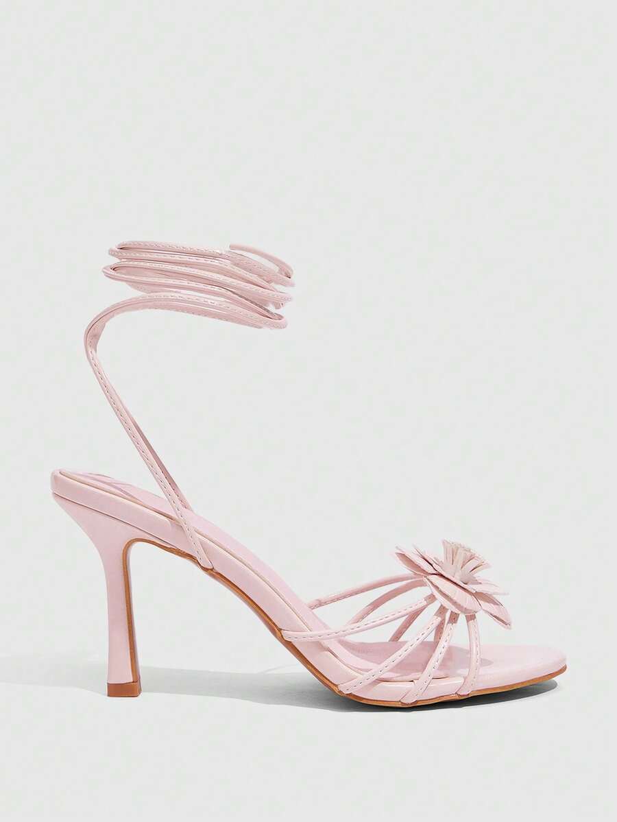 Women's round toe high heel sandals with brown flannel finish, floral trim detail, and strappy lace-up stiletto design.