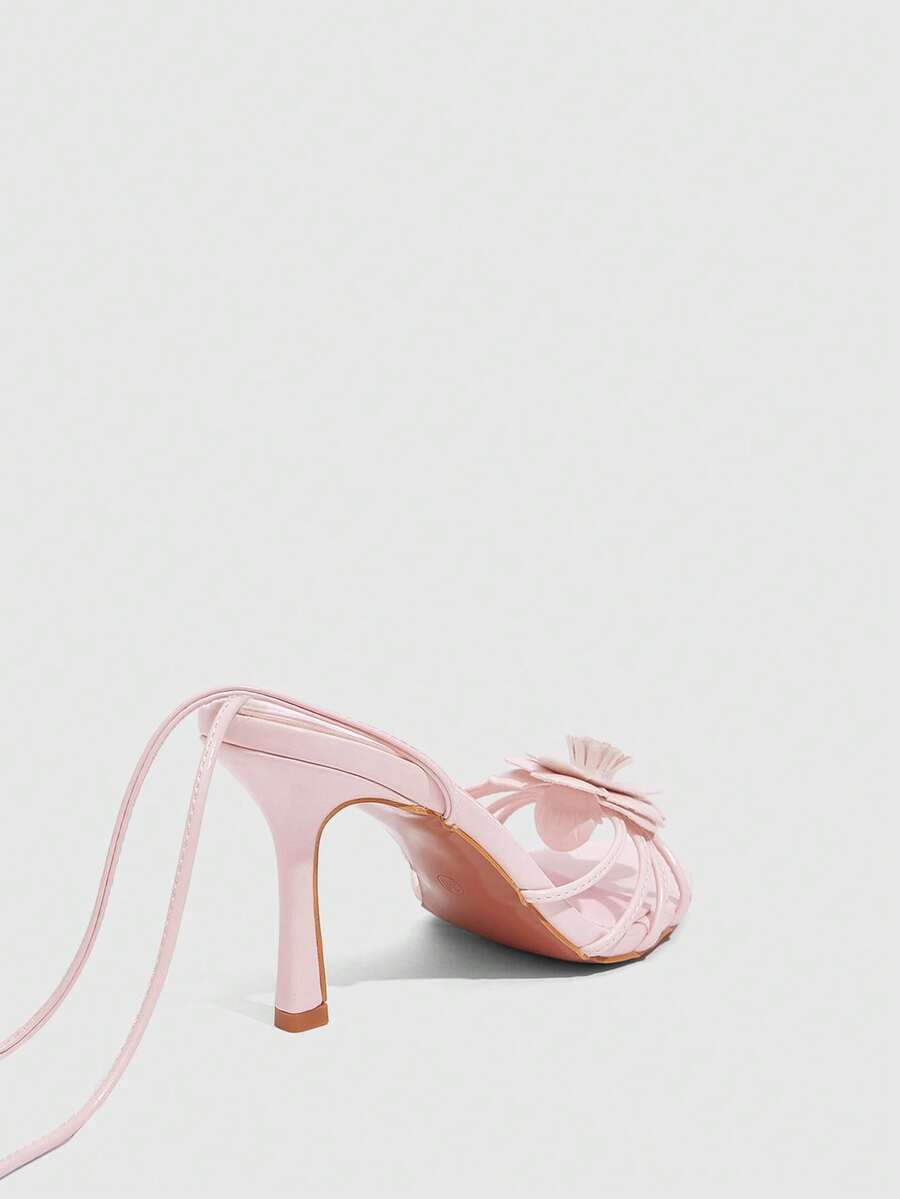 Women's round toe high heel sandals with brown flannel finish, floral trim detail, and strappy lace-up stiletto design.