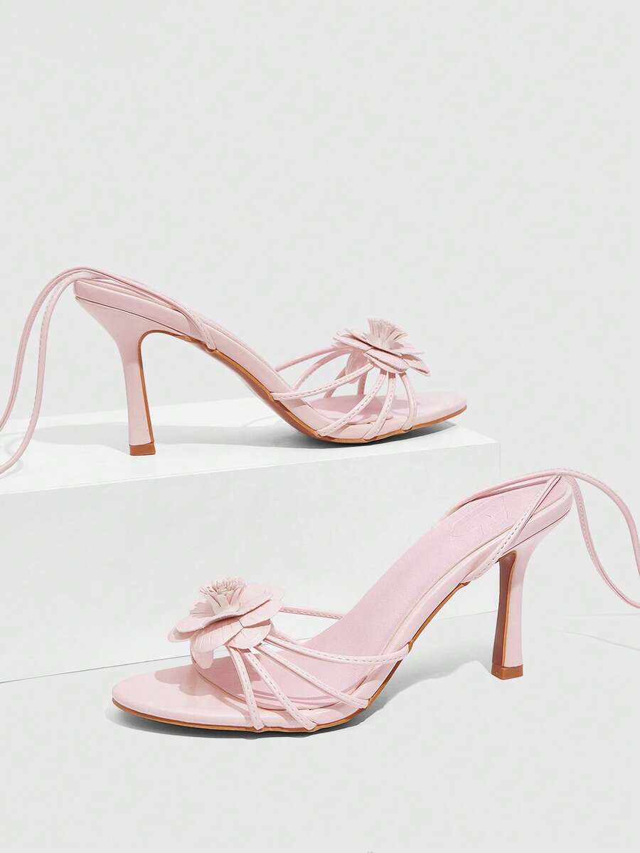 Women's round toe high heel sandals with brown flannel finish, floral trim detail, and strappy lace-up stiletto design.