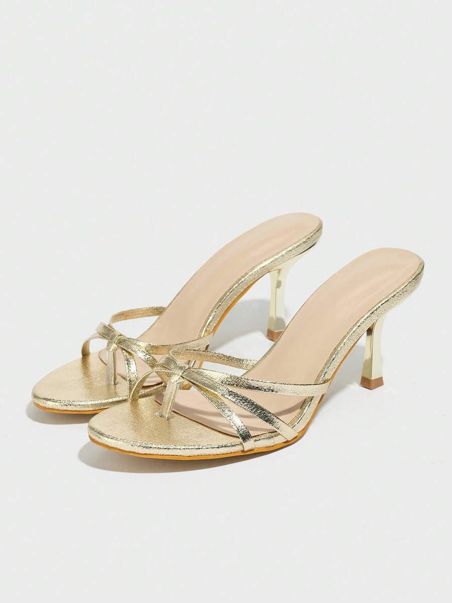 Women's slip-on stiletto heel platform sandals featuring a twist toe-post strap design and sleek finish.