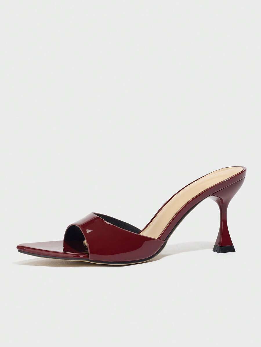 Burgundy pointed toe stiletto high heel dress mules with an open-back design and shiny patent finish