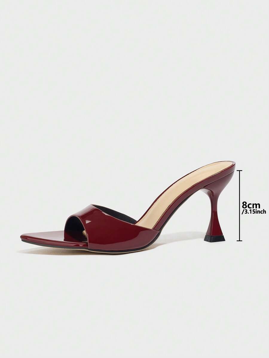 Burgundy pointed toe stiletto high heel dress mules with an open-back design and shiny patent finish