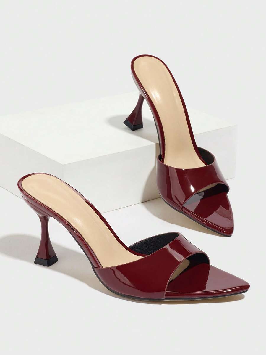 Burgundy pointed toe stiletto high heel dress mules with an open-back design and shiny patent finish