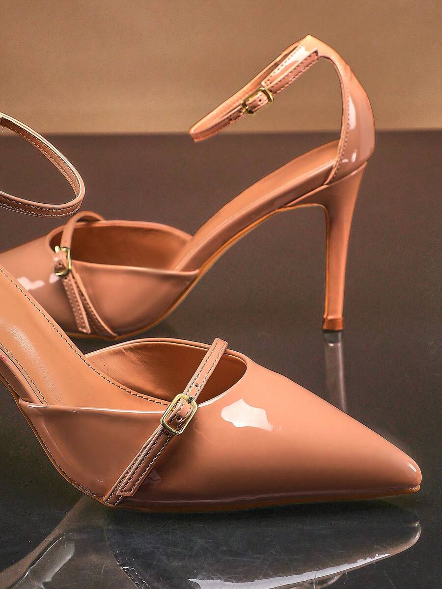 Women's pointed toe stiletto heel slingback pumps in chocolate brown with double metal buckle strap details.