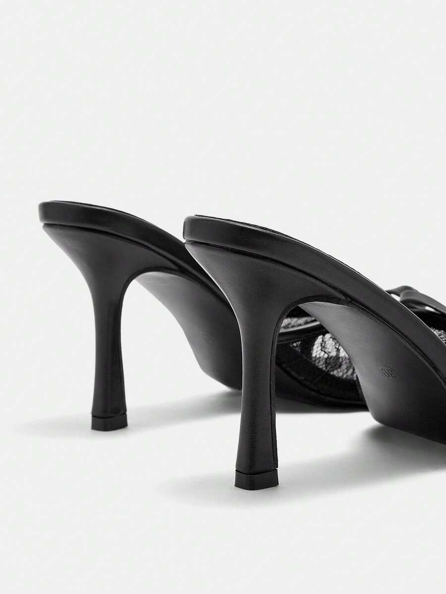 Women's black lace slip-on mule sandals featuring a high stiletto heel, open toe, and bow embellishment.