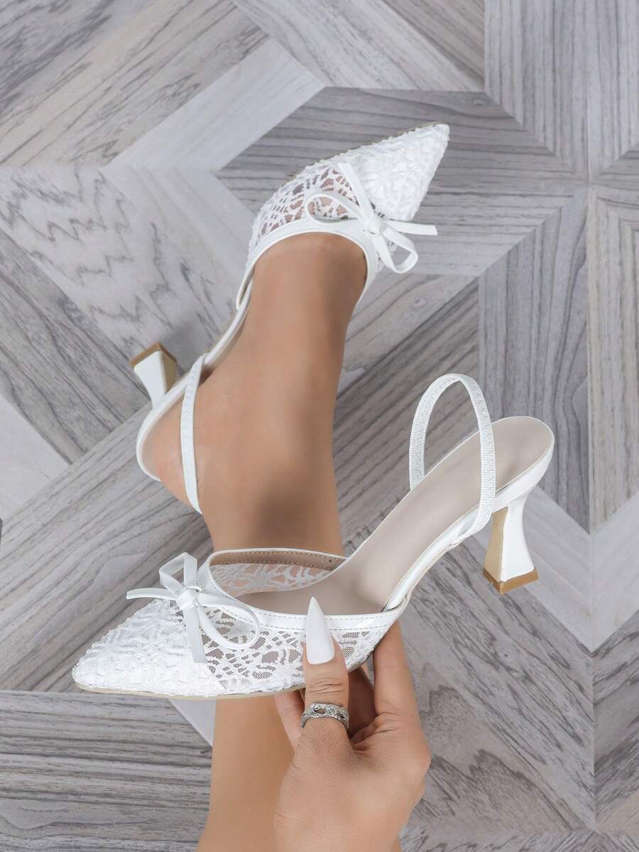 Pointed toe stiletto high heels featuring white mesh lace upper, bowknot accent, and slingback buckle strap.