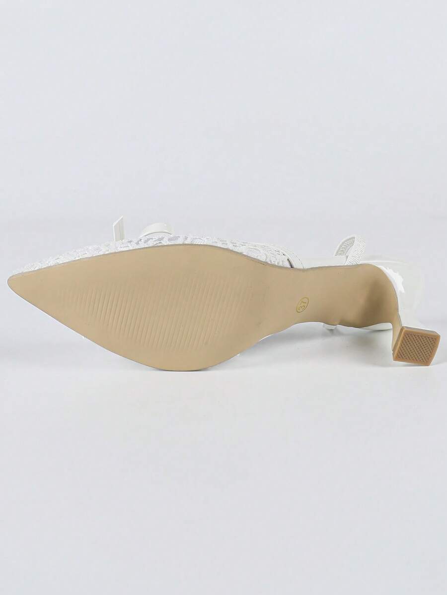Pointed toe stiletto high heels featuring white mesh lace upper, bowknot accent, and slingback buckle strap.