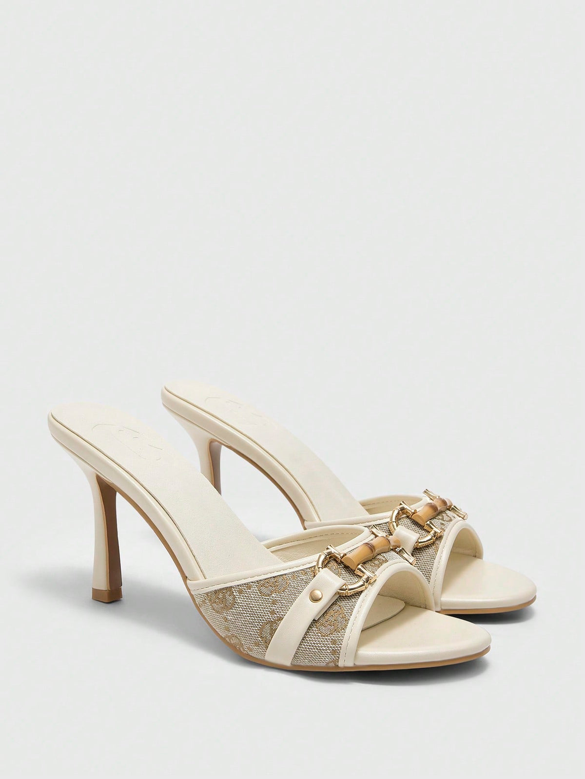 Beige pointed toe mule high heel sandals featuring gold buckle accent