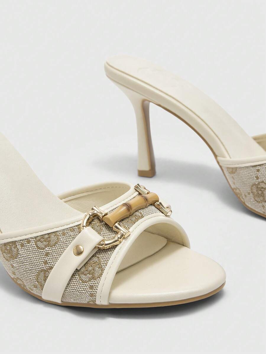 Beige pointed toe mule high heel sandals featuring gold buckle accent