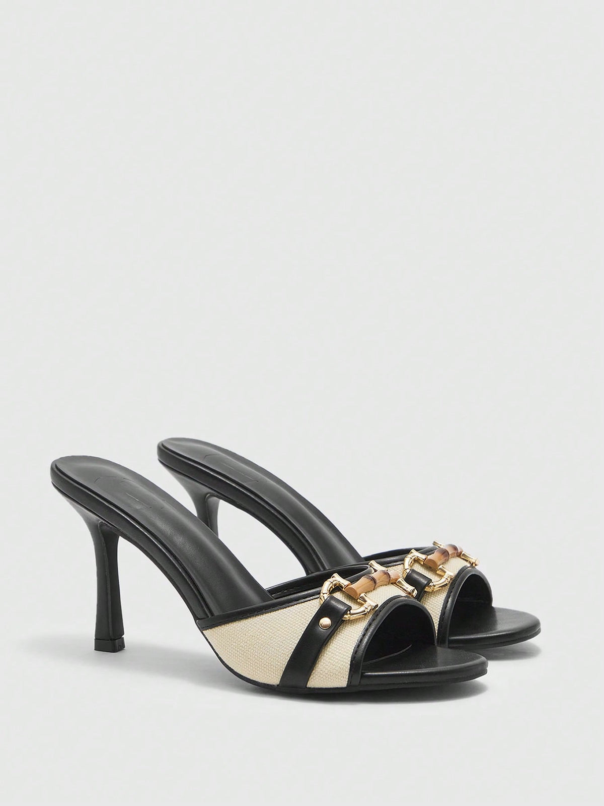 Women's open toe high heel slingback sandals featuring metal bamboo joint accent and stiletto heels.