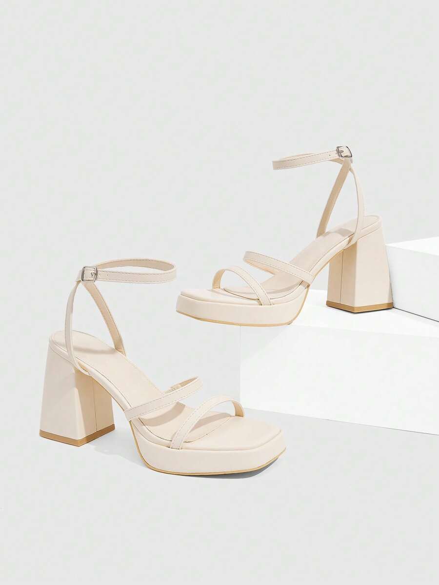 Women's high-heeled sandals with textured pattern, open toe design, chunky heel, and adjustable ankle buckle strap.