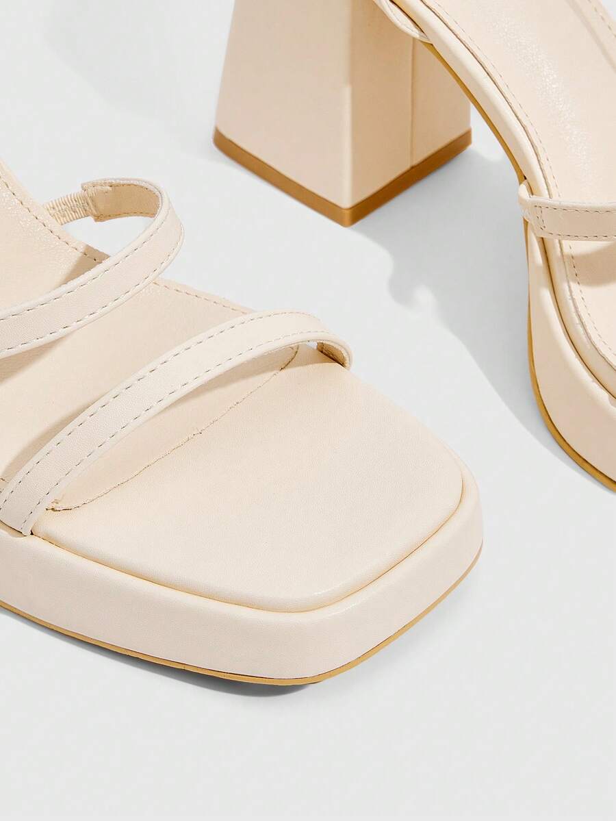 Women's high-heeled sandals with textured pattern, open toe design, chunky heel, and adjustable ankle buckle strap.