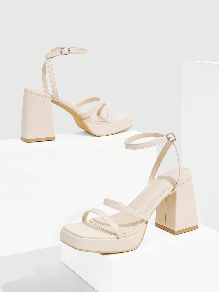 Women's high-heeled sandals with textured pattern, open toe design, chunky heel, and adjustable ankle buckle strap.