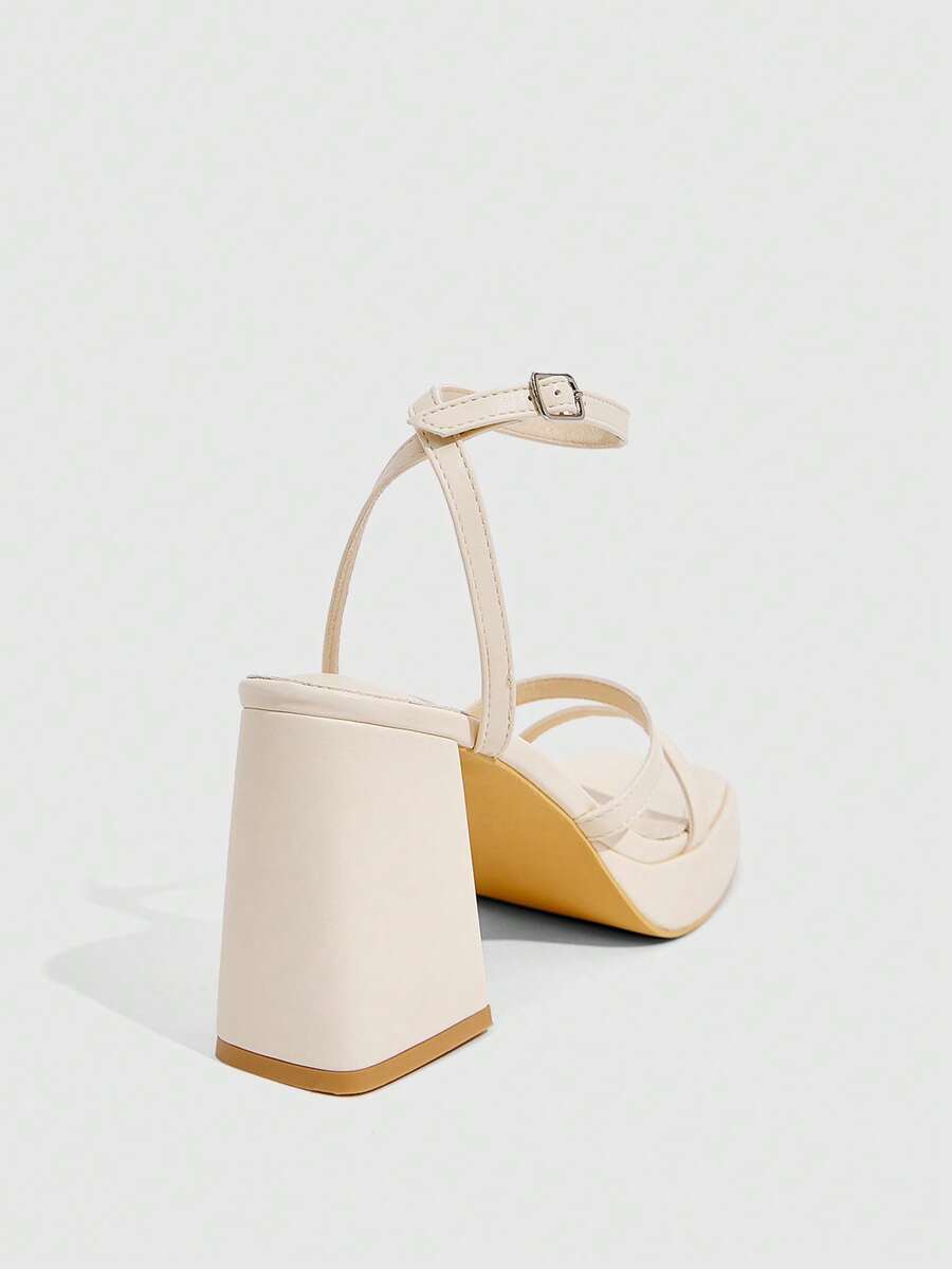 Women's high-heeled sandals with textured pattern, open toe design, chunky heel, and adjustable ankle buckle strap.