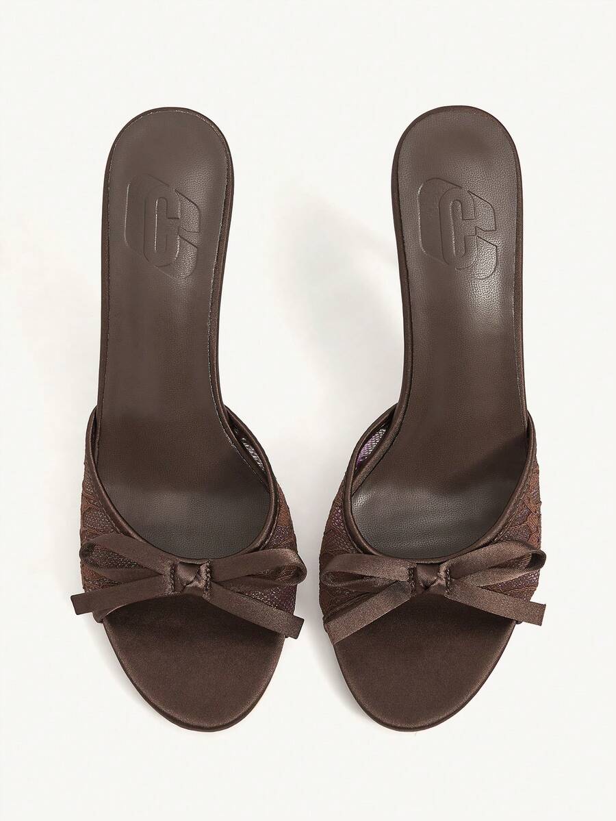 Elegant women's pointed toe high heel mules crafted from smooth PU leather with stiletto heels and delicate bow detail.
