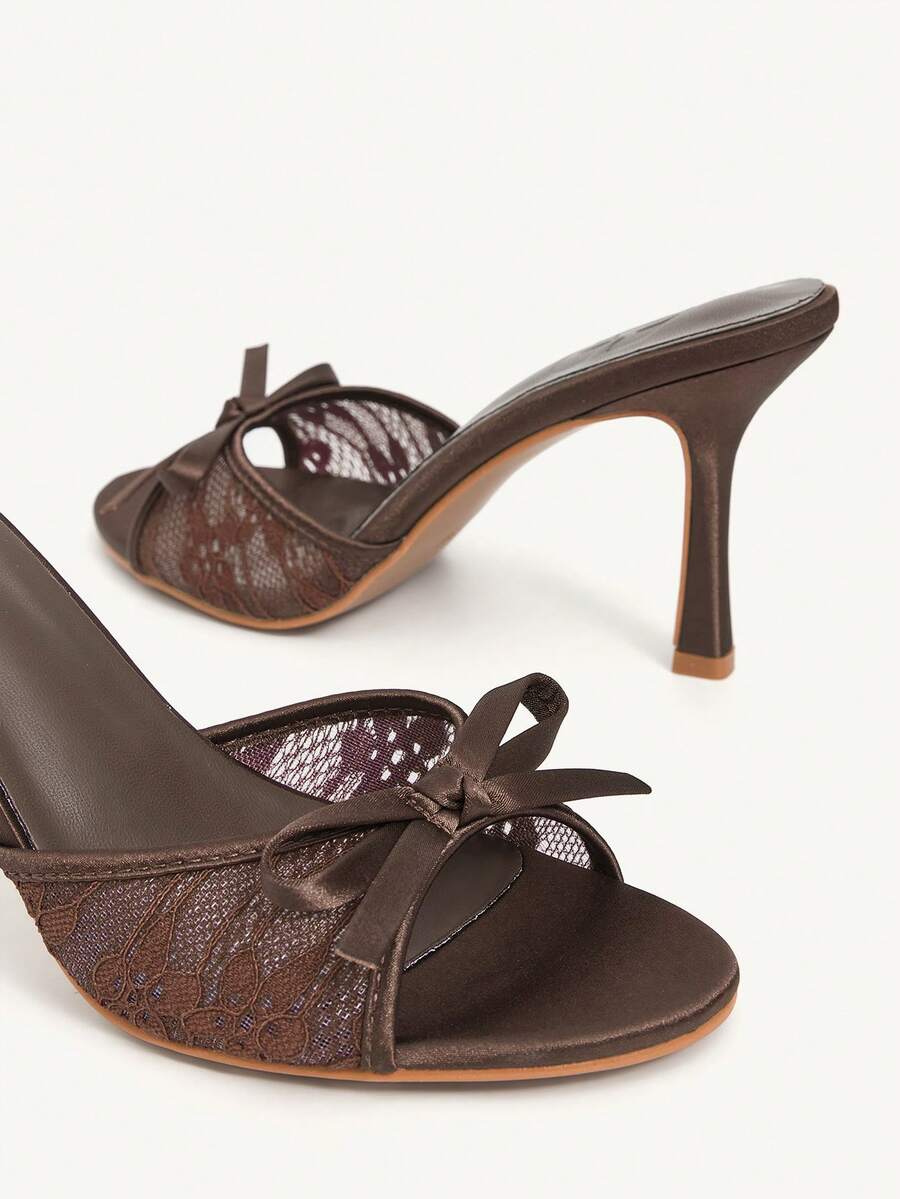 Elegant women's pointed toe high heel mules crafted from smooth PU leather with stiletto heels and delicate bow detail.