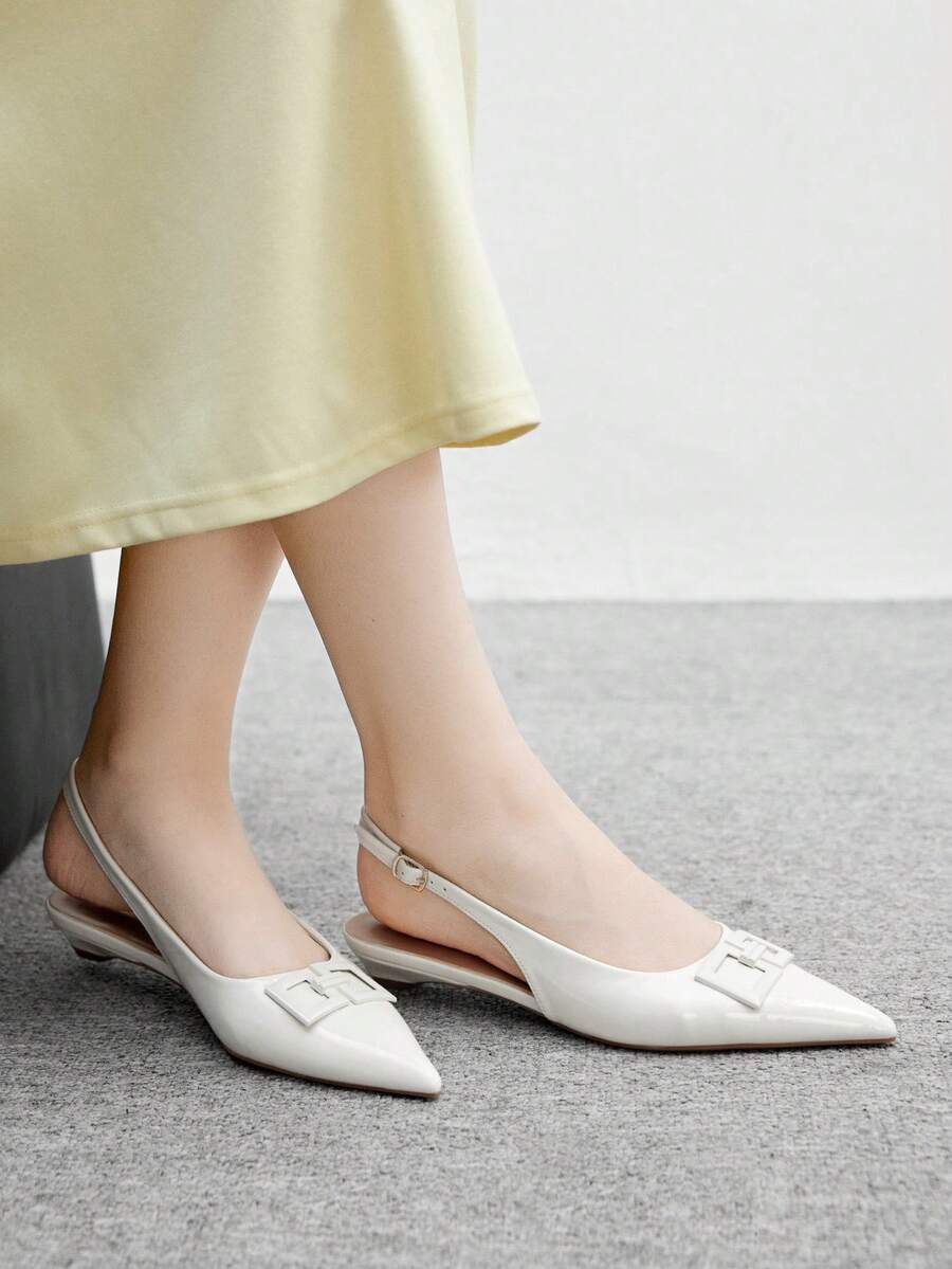 Women's pointed toe low wedge flat shoes crafted in PU leather with a slingback strap and stylish metal buckle detail.