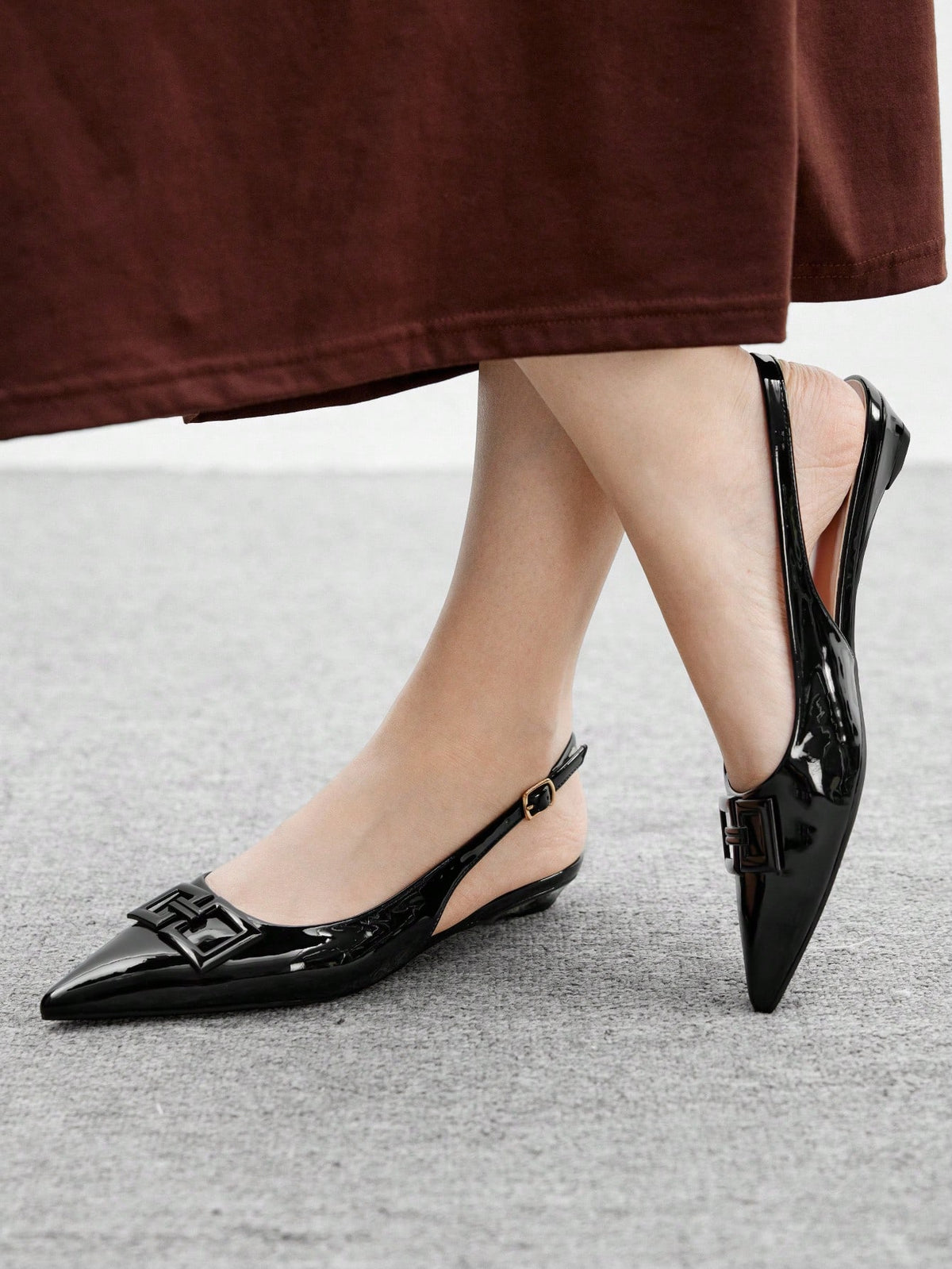 Women's pointed toe low wedge flat shoes crafted in PU leather with a slingback strap and stylish metal buckle detail.