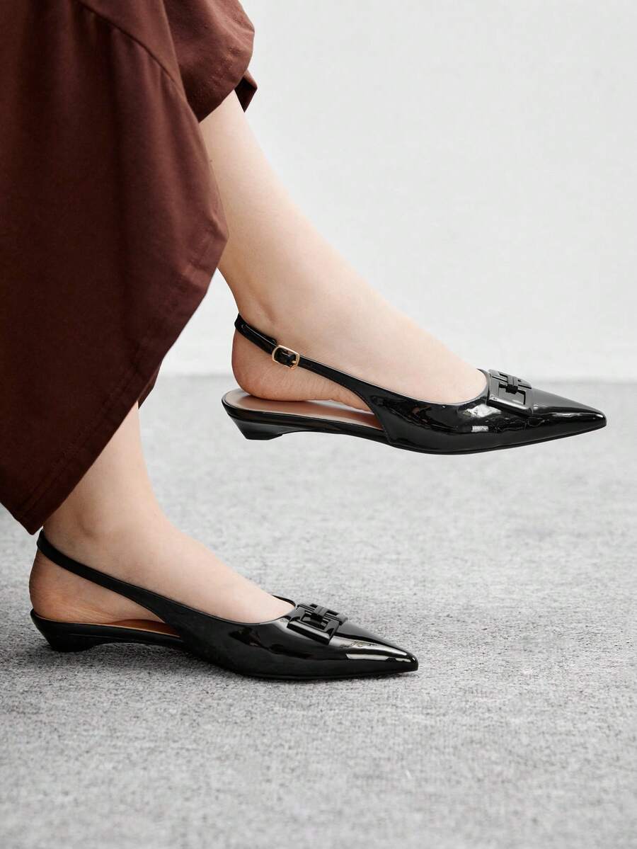 Women's pointed toe low wedge flat shoes crafted in PU leather with a slingback strap and stylish metal buckle detail.