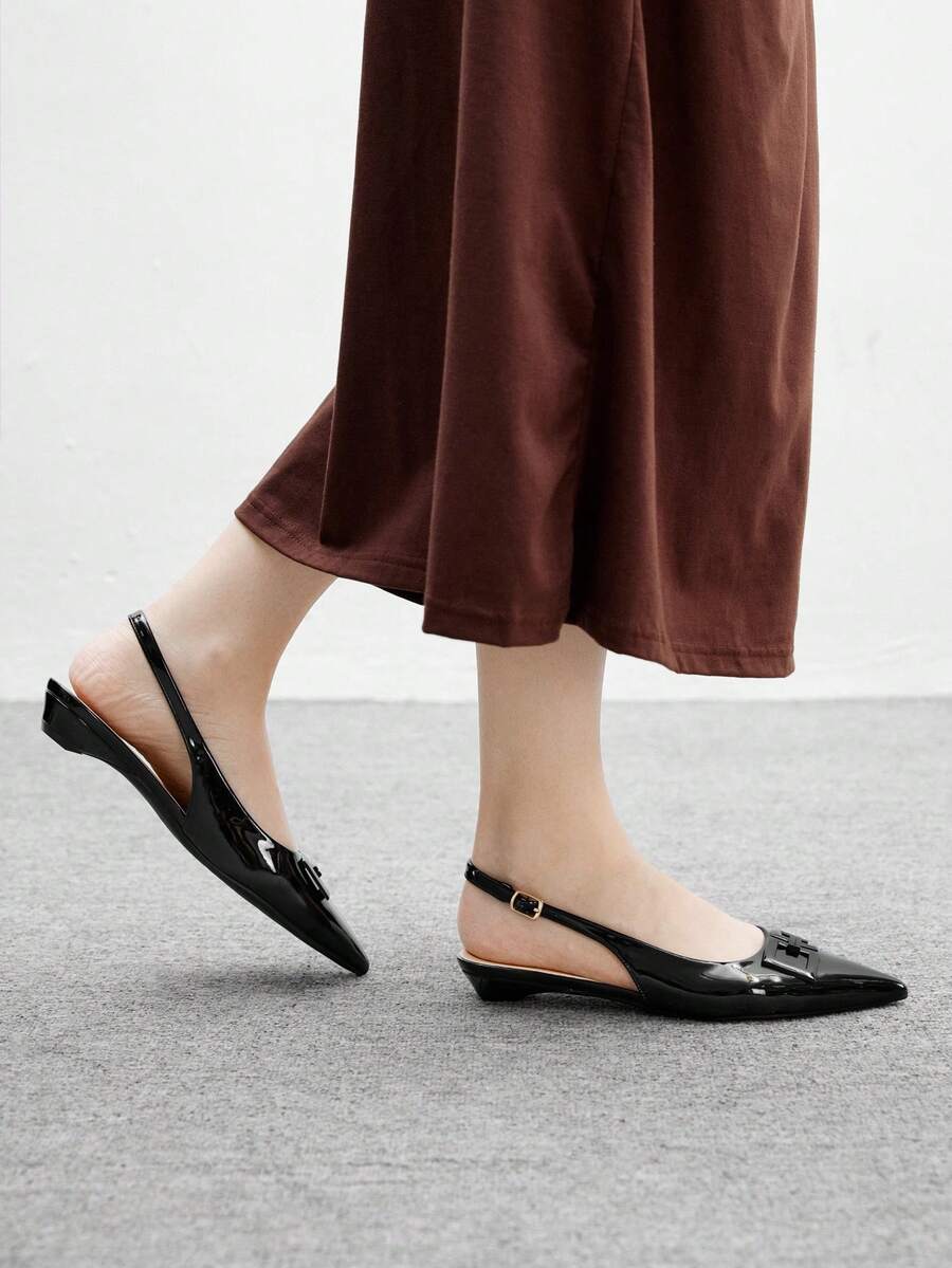 Women's pointed toe low wedge flat shoes crafted in PU leather with a slingback strap and stylish metal buckle detail.